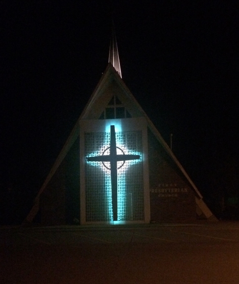 A-frame church with backlit neon cross and breezeblock wall